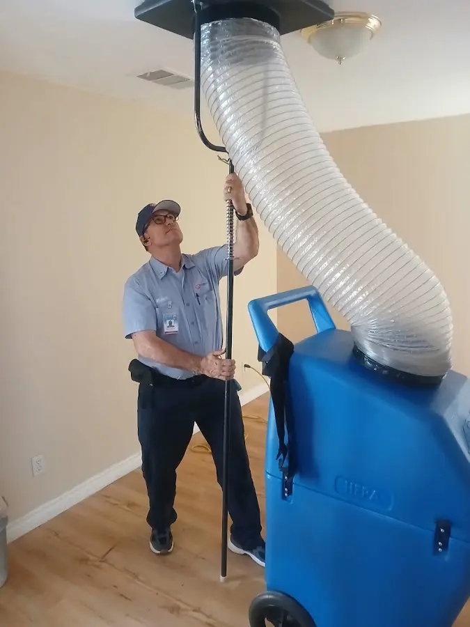 Furnace Tune-Up technician using HEPA equipment in Manassas Park
